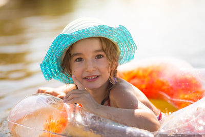 Portrait of smiling girl swimming in lake