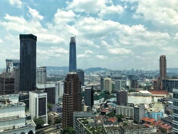 High angle view of modern buildings in city against sky