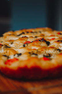 Close-up of food on table. homemade italian focaccia, with tomato, pink pepper and olive oil.