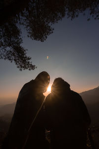 Silhouette people against sky during sunset