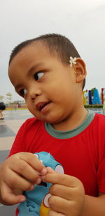 Close-up portrait of cute boy holding baby