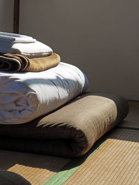 Sunlight falling on futon over tatami mat at home