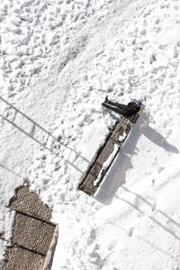 High angle view of snow on cobblestone street