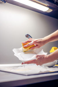 Cropped hand of woman holding paper