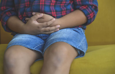Low section of woman sitting
