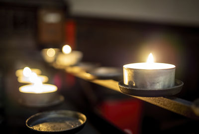 Close-up of illuminated tea light candles