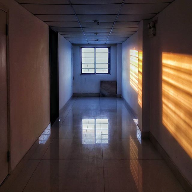 indoors, architecture, built structure, ceiling, corridor, empty, window, flooring, absence, illuminated, interior, the way forward, sunlight, no people, wall - building feature, wall, building, diminishing perspective, tiled floor, in a row