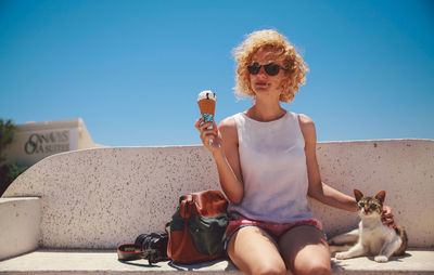 Portrait of young woman sitting on bench