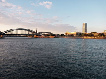 Bridge over river with city in background