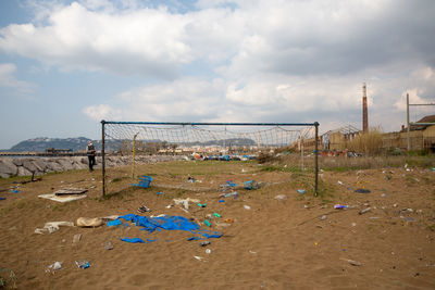 Garbage on sand at beach against sky