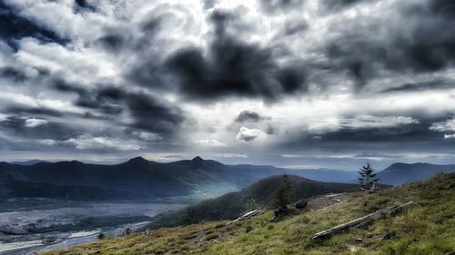 Scenic view of mountains against cloudy sky