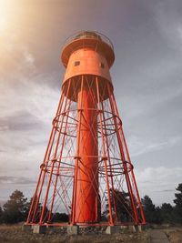 Low angle view of water tower against cloudy sky during sunset