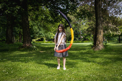 Portrait of a girl with a belgian flag in the park.