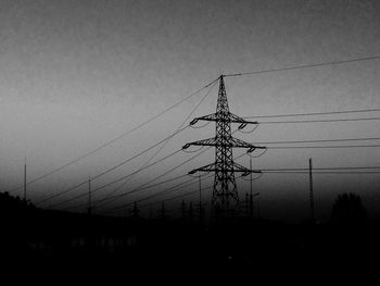 Low angle view of electricity pylon against sky
