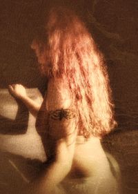 Midsection of woman with shadow at night