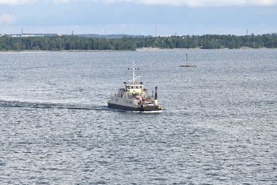 Boat sailing in sea against sky