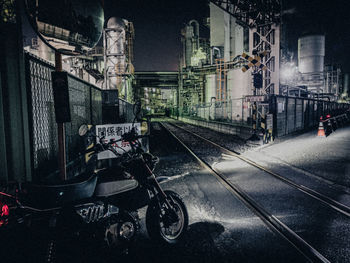 Train on railroad tracks in city at night