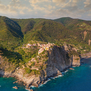 Scenic view of sea and mountains against sky