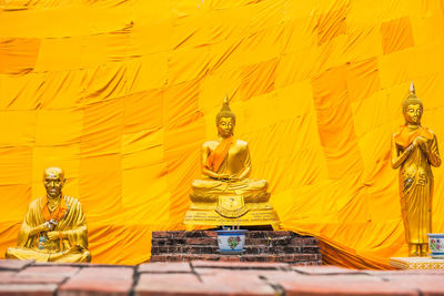 Statue of buddha against building