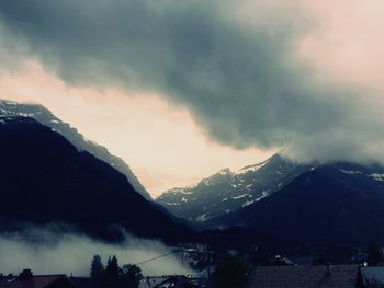 Scenic view of mountains against cloudy sky