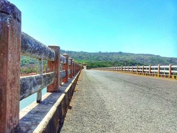 Empty road along built structures