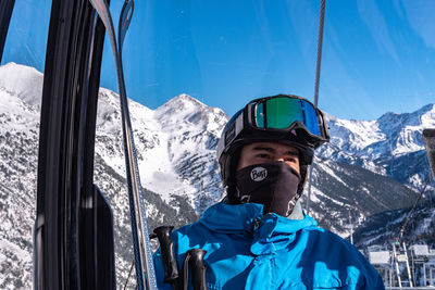 Portrait of man against snowcapped mountains