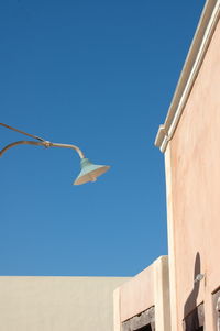 Low angle view of bird flying against clear blue sky