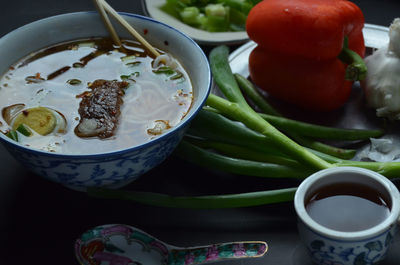 Asian inspired beef noodle soup with green onions, tea