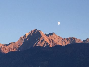 Scenic view of snowcapped mountains against clear sky