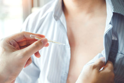 Midsection of couple holding hands