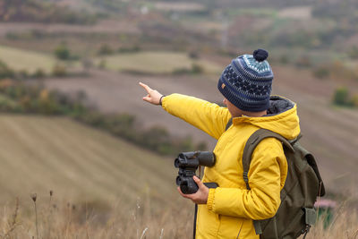 Rear view of woman holding umbrella