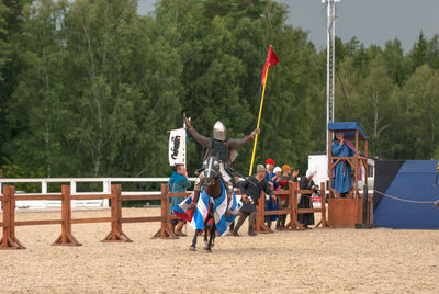 Full length of man riding horse during equestrian event