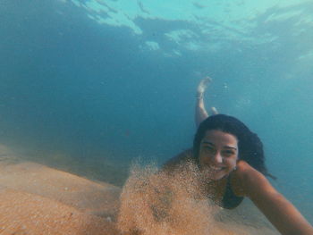 Portrait of man swimming underwater