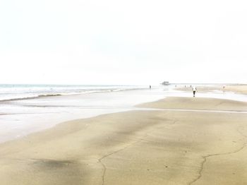 Scenic view of beach against clear sky