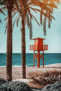 Lifeguard hut on beach against sky