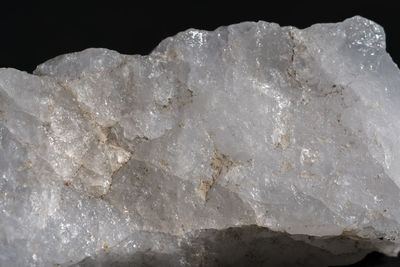 Close-up of rocks on rock against black background