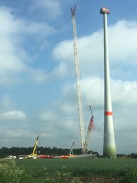 Low angle view of cranes against sky