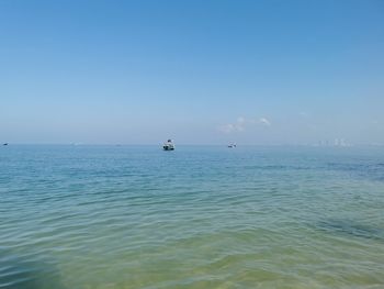 Scenic view of sea against clear blue sky