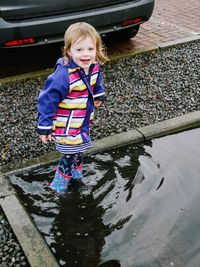 Cute girl standing in water