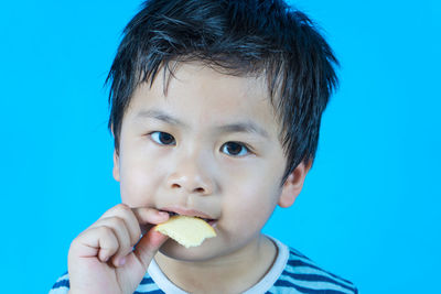 Portrait of cute boy eating food