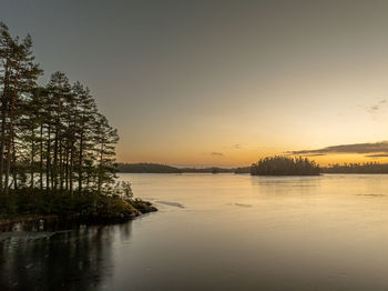 Scenic view of lake against sky during sunset