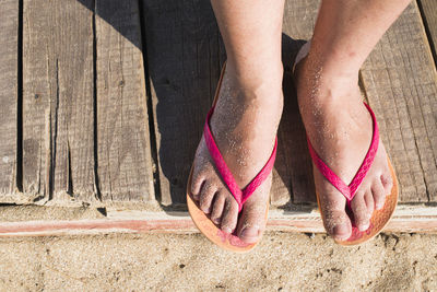 Low section of woman standing on beach