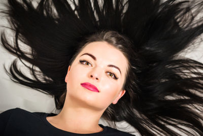 Close-up portrait of beautiful young woman with long black hair