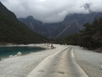 Scenic view of mountains against cloudy sky