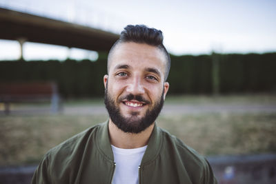 Portait of smiling man with beard and shaved head