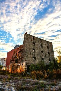 Low angle view of building against cloudy sky