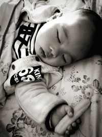 Close-up of baby sleeping on bed