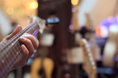 Close-up of man playing guitar