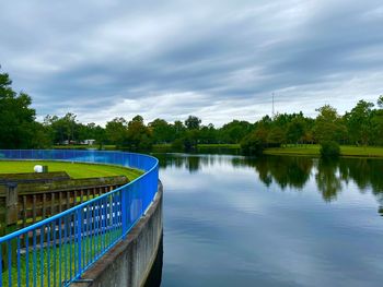 Scenic view of swimming pool by lake against sky