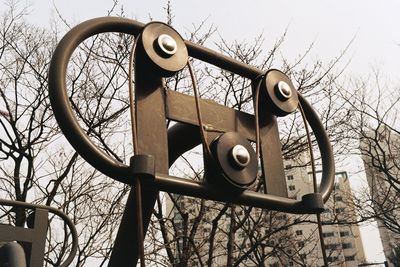 Low angle view of telephone pole against sky
